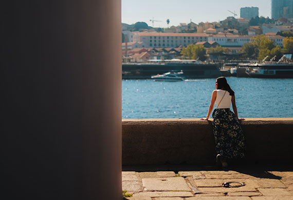 Image of a person sightseeing in the lake with a big column on the side