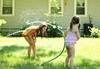Image of Image of children playing with a water hose
