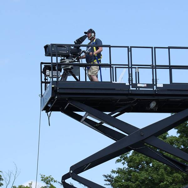 Image of a cameraman using Canon broadcast gear on an elevated platform