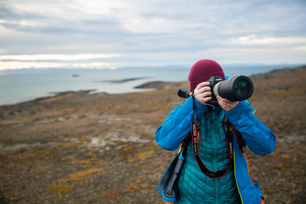 Portrait image of Liz Carlson photographing in the artic
