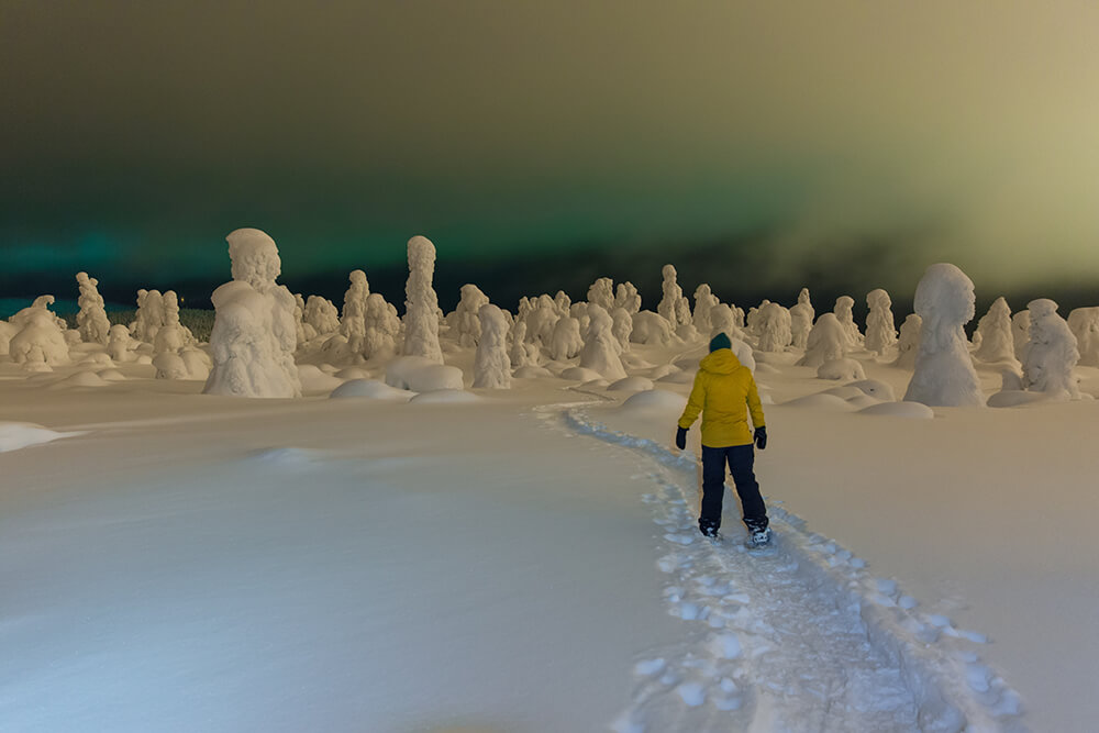 Snowshoeing under the aurora in northern Finland.jpg	
