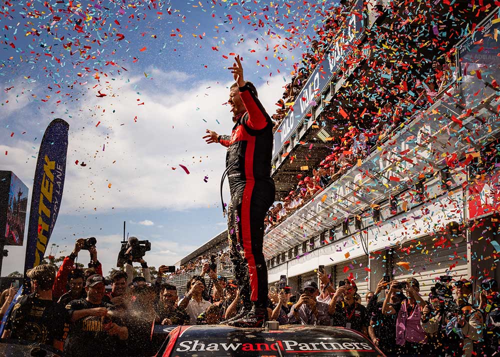 Image of the winning racer on top of his racecar photographed by Tenayah McLeod