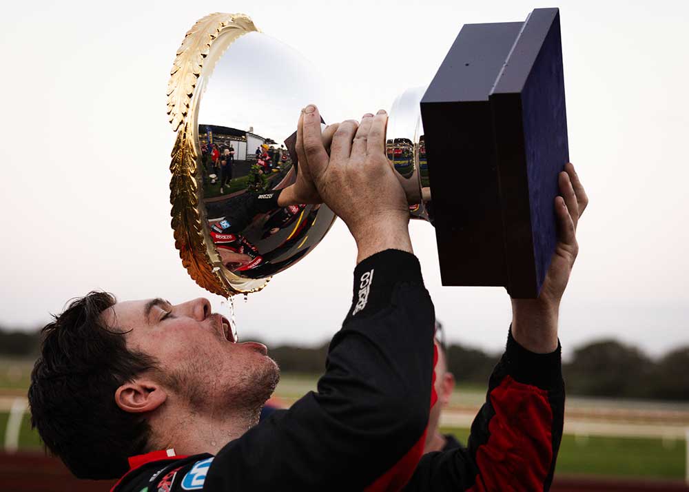 Image of a racer drinking from his trophy photographed by Tenayah McLeod