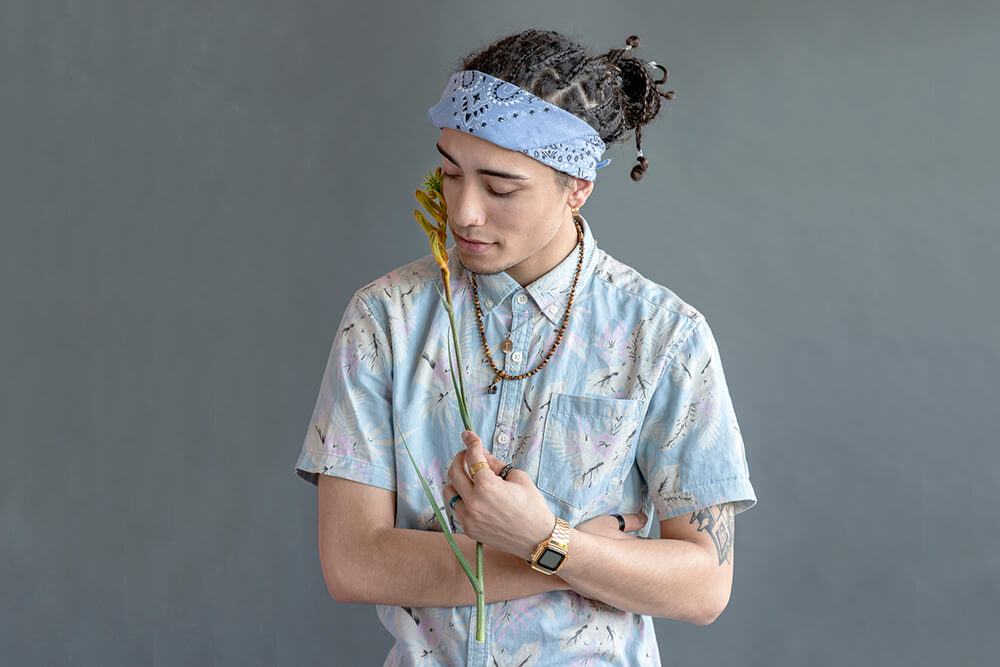 Man posing with leaf in a studio