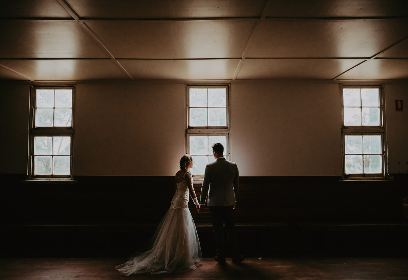 Bride and groom peeking out the window taken by James Simmons