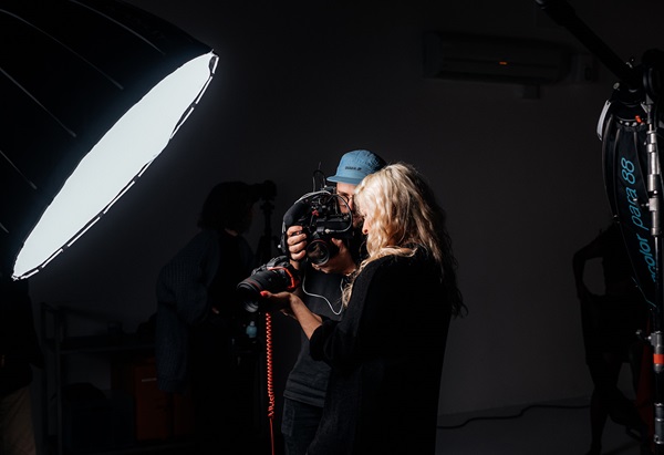Canon camera in a professional studio setup with a large softbox light illuminating the scene.