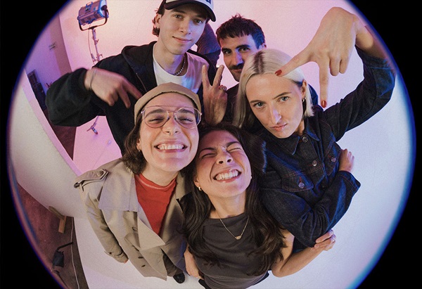 The Circle ambassadors looking down toward a fisheye camera lens, creating a circular group portrait.