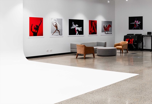 Contemporary art gallery featuring framed photography and artwork displayed on white walls.
