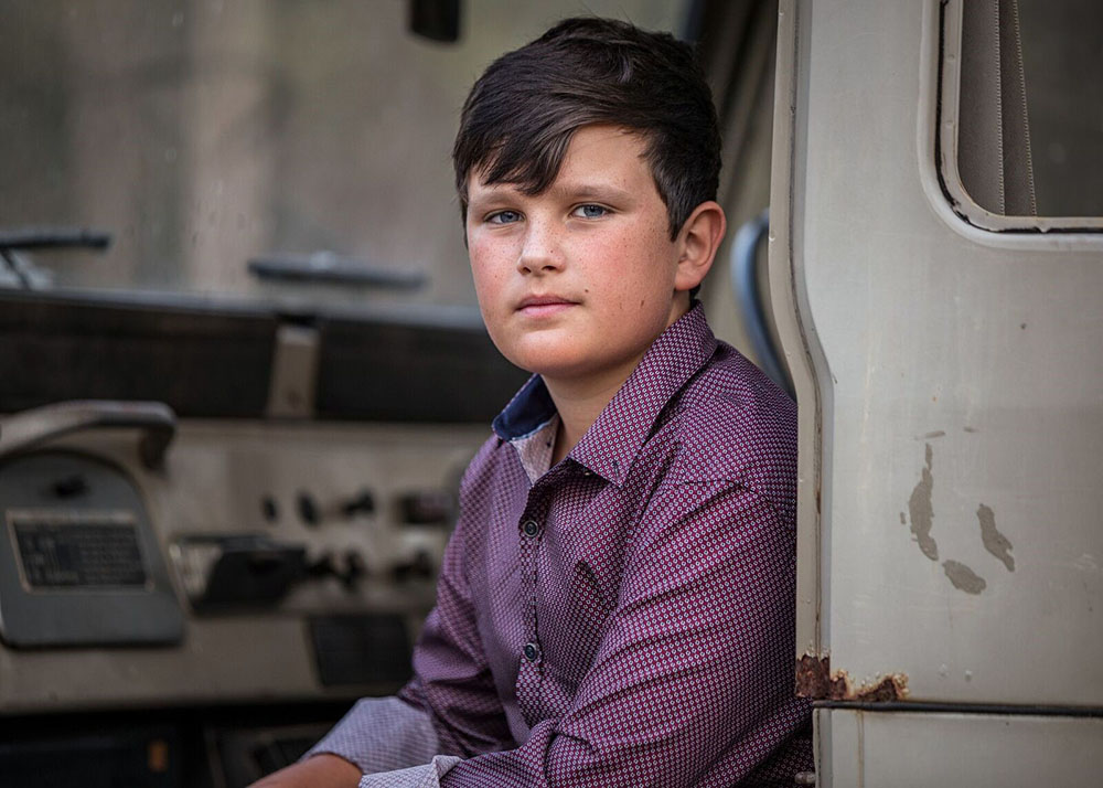 portrait image of kid sitting in car