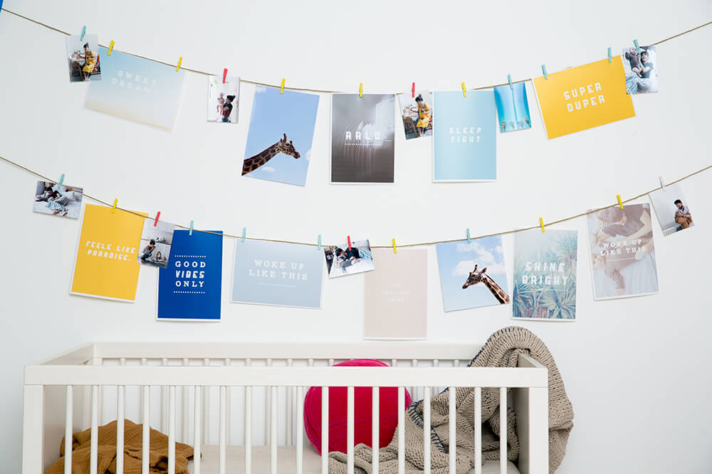DIY nursery decoration - images pegged on string in baby room