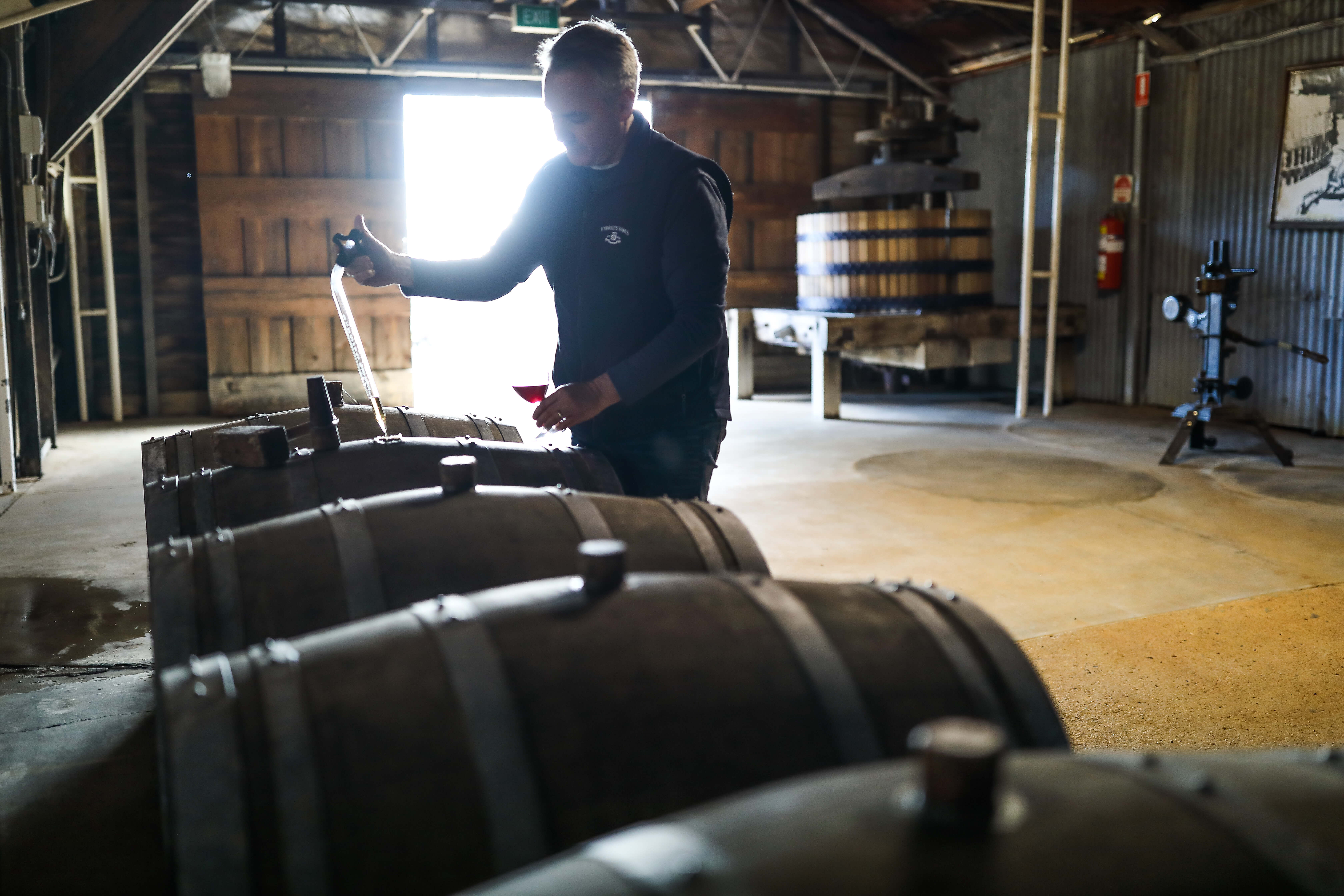 Image of winemaker testing wine.