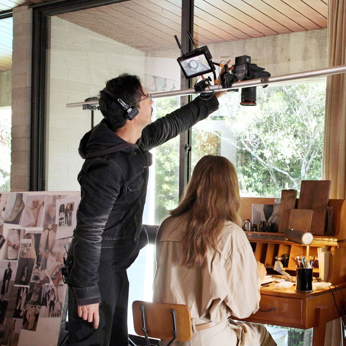 Image of Steven Chee using a Canon cinema camera to capture the model