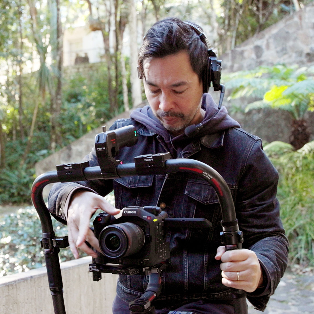Image of Steven Chee using a Canon cinema camera attached to a rig
