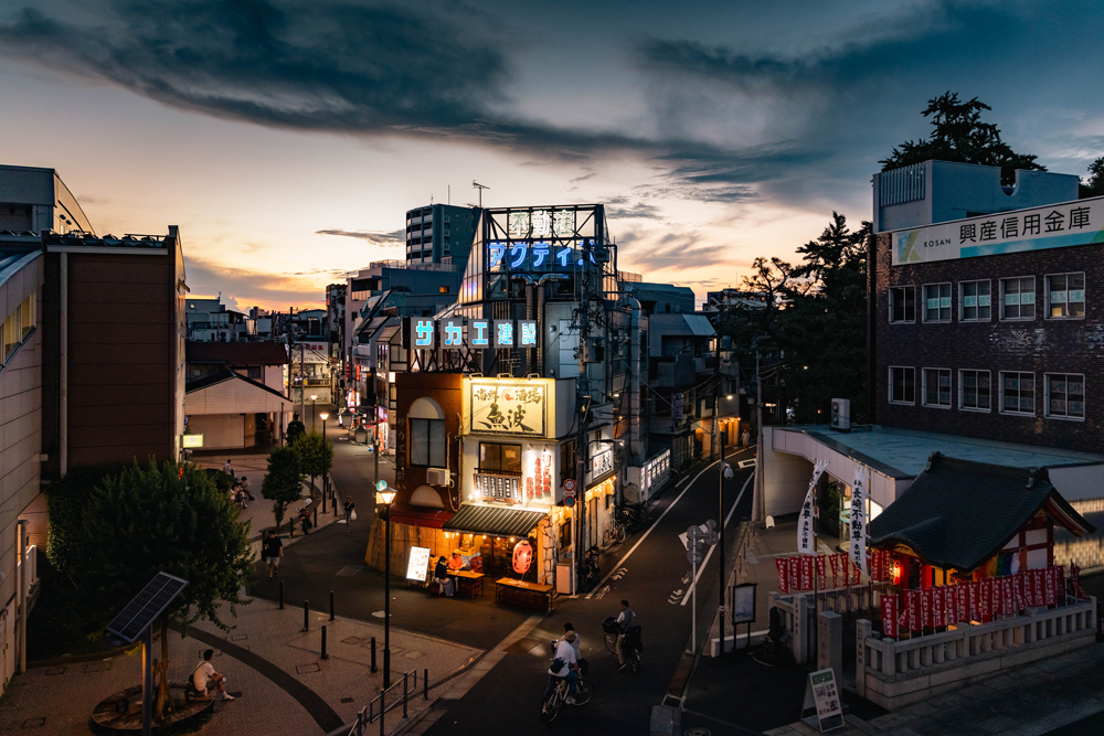 Illuminated streets in Toshima beneath the remaining colour of the sunset sky