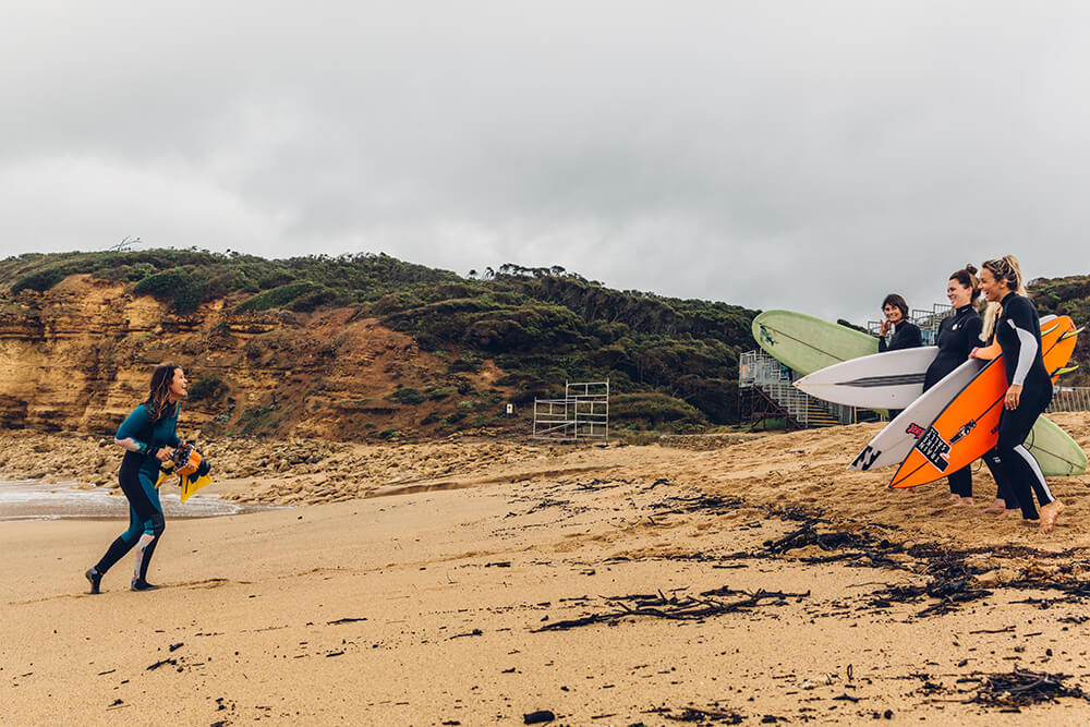 Fran Miller photographing surfers in the sand