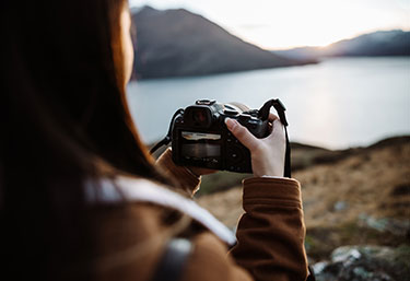 Image of a woman using a Canon EOS camera