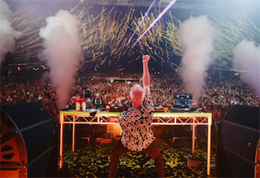 Image of Fatboy Slim performing for a big crowd