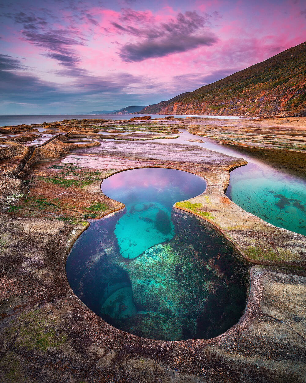 Landscape image of rockpools at sunset
