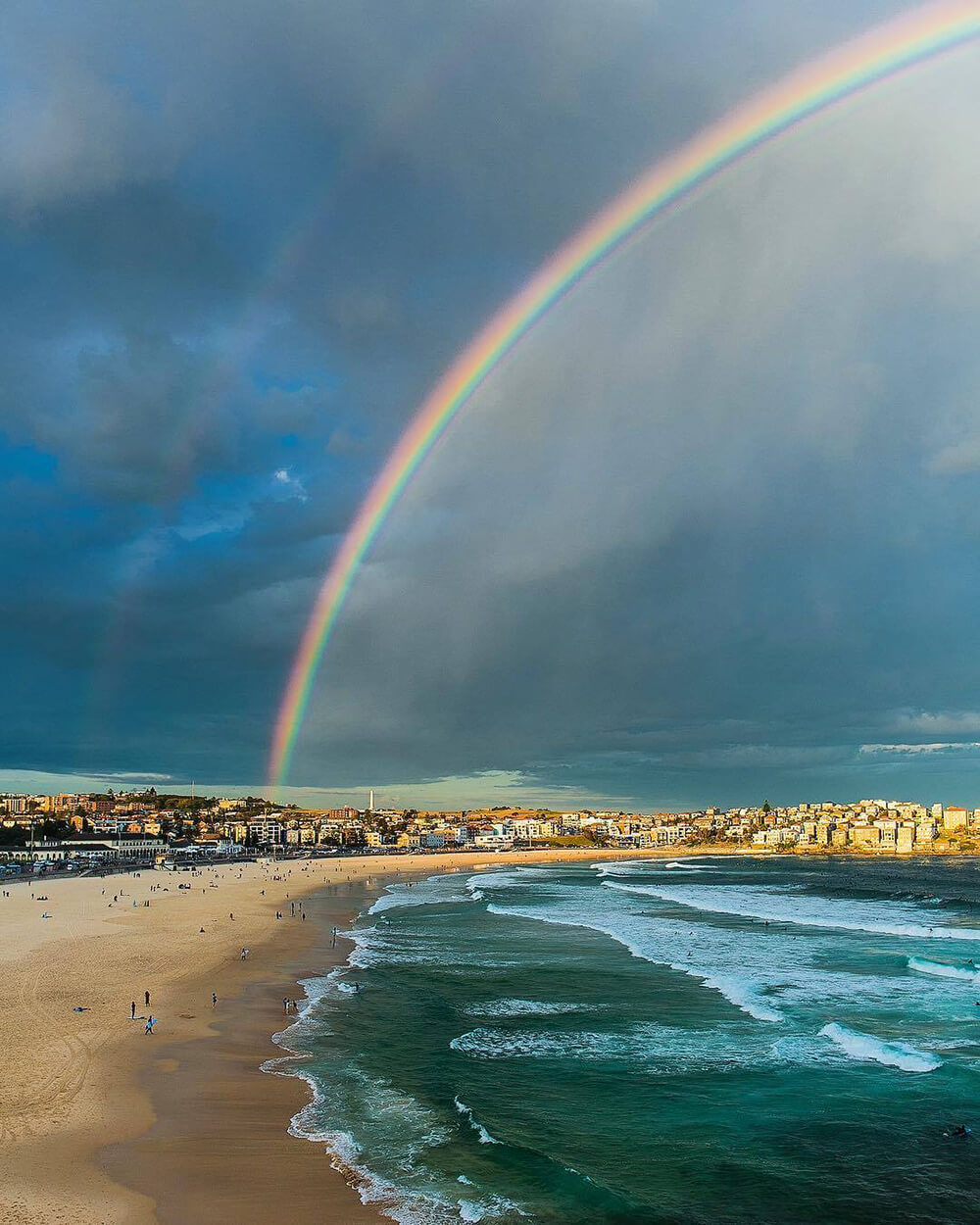 Landscape image of rainbow at beach