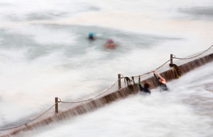 3 Swimmers enjoying the Cronulla ocean pool in spite of the swell.png	