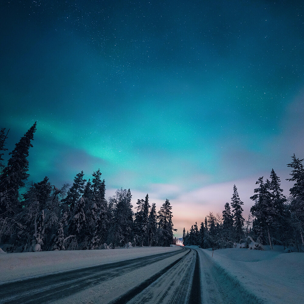 Photo of a highway under the Aurora in Finland. Shot by Elaine Li