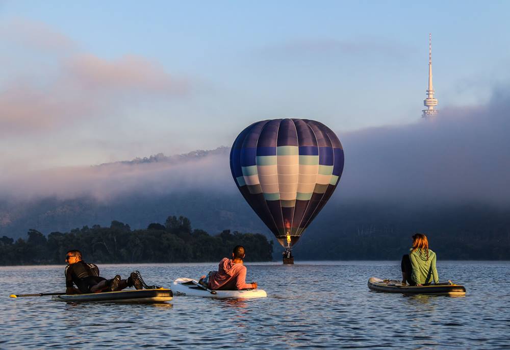 Hot air balloon over lake