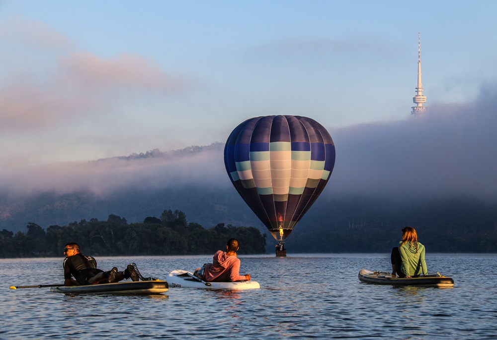 Hot air balloon over lake