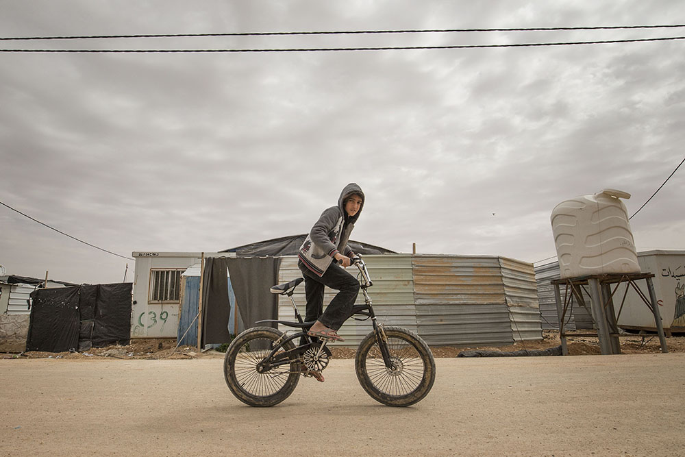 image of refugee kid on a bike