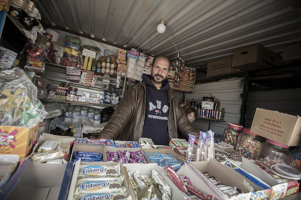 image of man in his shop in refugee camp