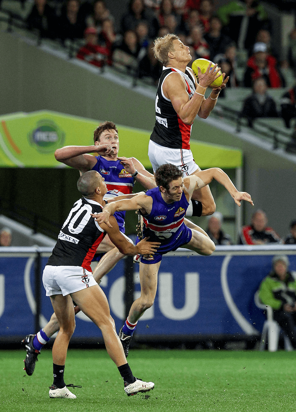 St Kilda’s Nick Riewoldt takes a mark over Western Bulldogs player Robert Murphy, before tumbling to the ground during the second preliminary final clash in 2010 at the MCG. Canon EOS 1D Mark III, 400m lens. 1/250s @ f4, ISO 4000.