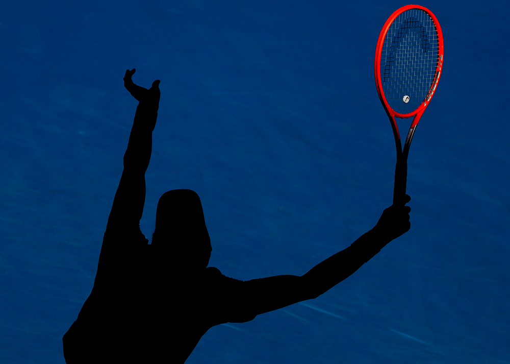 Kwon Soon-woo of South Korea serves in the late afternoon sun during his second round match against Denis Shapovalov of Canada on January 19th 2022 CREDIT: AP Photo / Hamish Blair