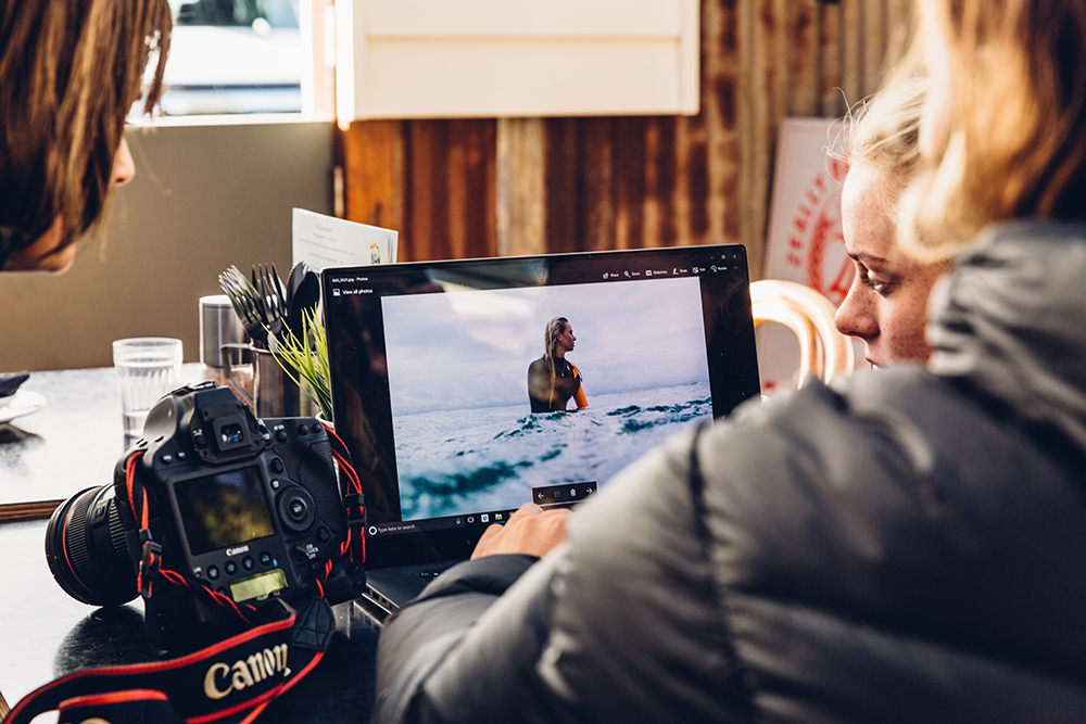 Surfer Macy Callaghan reviewing an image of herself in the surf