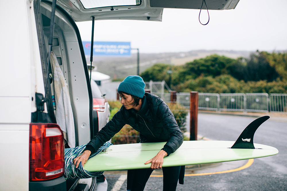 Photo of Belinda Baggs getting ready for a surf at Bells Beach