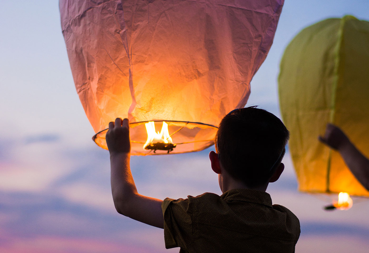 Kid holding a sky lantern