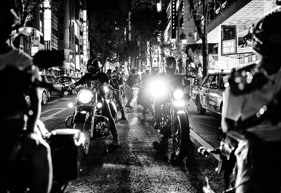 black and white image of motorcyclists in the streets of Tokyo, taken with the EOS R. Photo by Maria Boyadgis