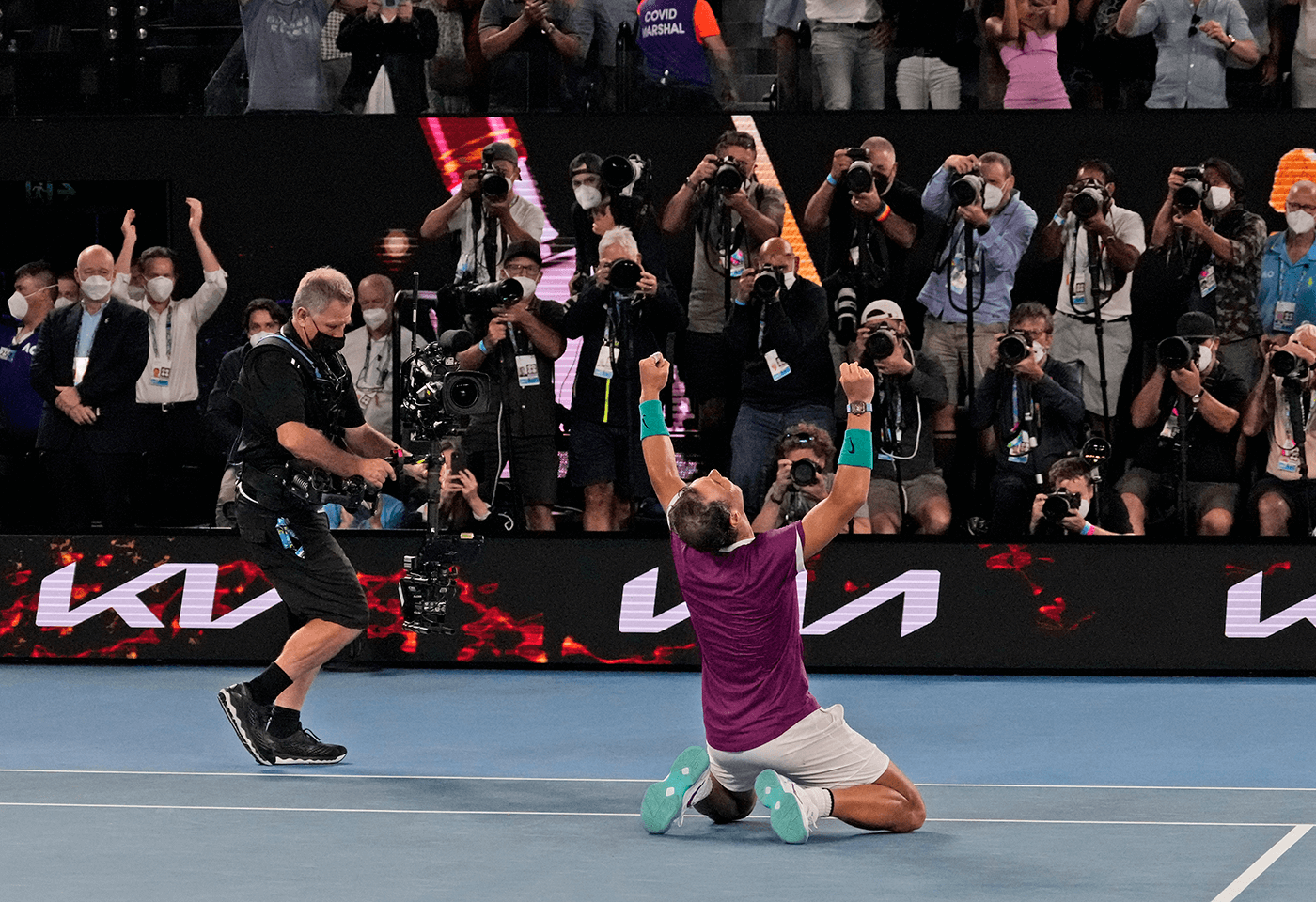 Sports photographer, Hamish Blair at this year’s major Australian tennis event pictured in back row, fifth photographer from the left. CREDIT: AP Photo / Simon Baker