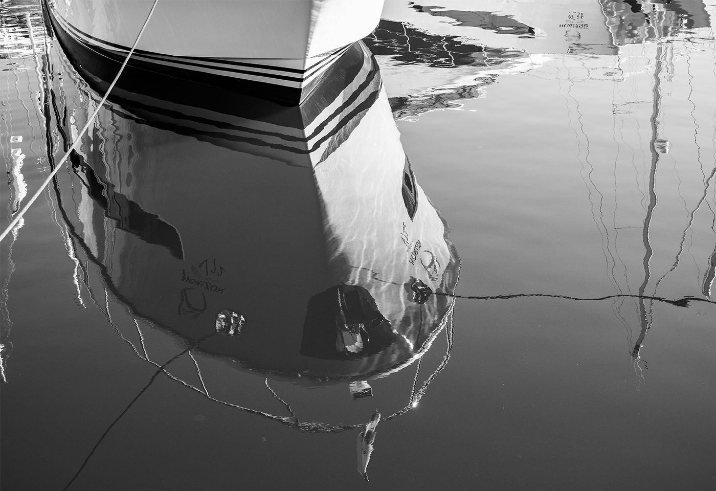 Black and white reflection of boat on water