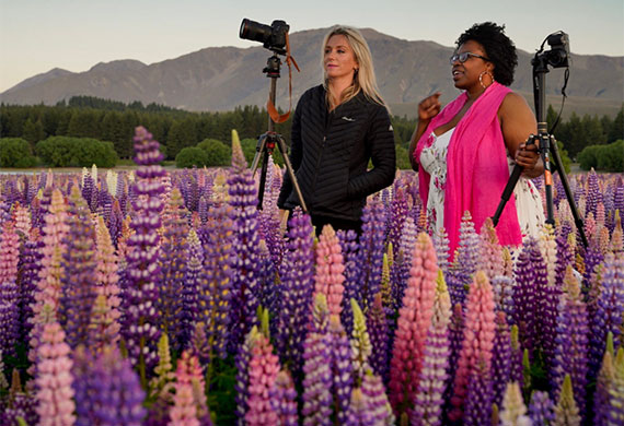 Image of ladies taking photos on a flower field. Photo by Rach Stewart
