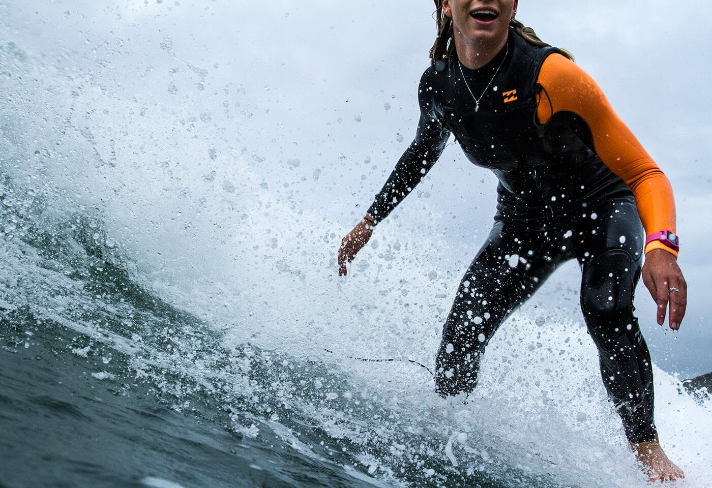photo of a female surfer catching a wave