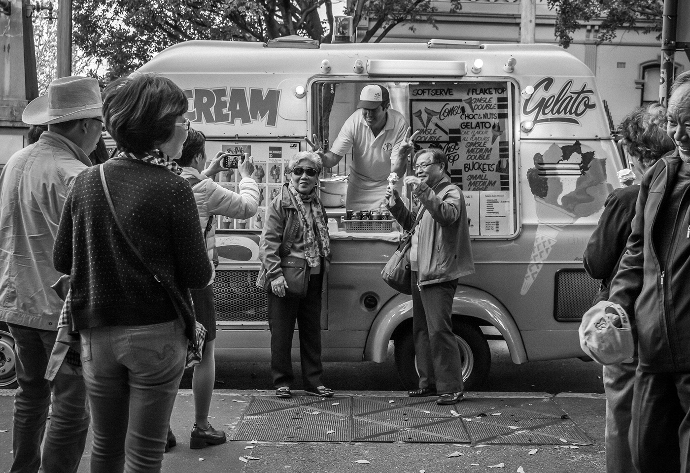 Tourists pose for photo next to icecream truck