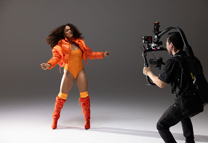 Steven Chee filming a dancer dancing in orange outfit using the EOS R5 Mark II camera