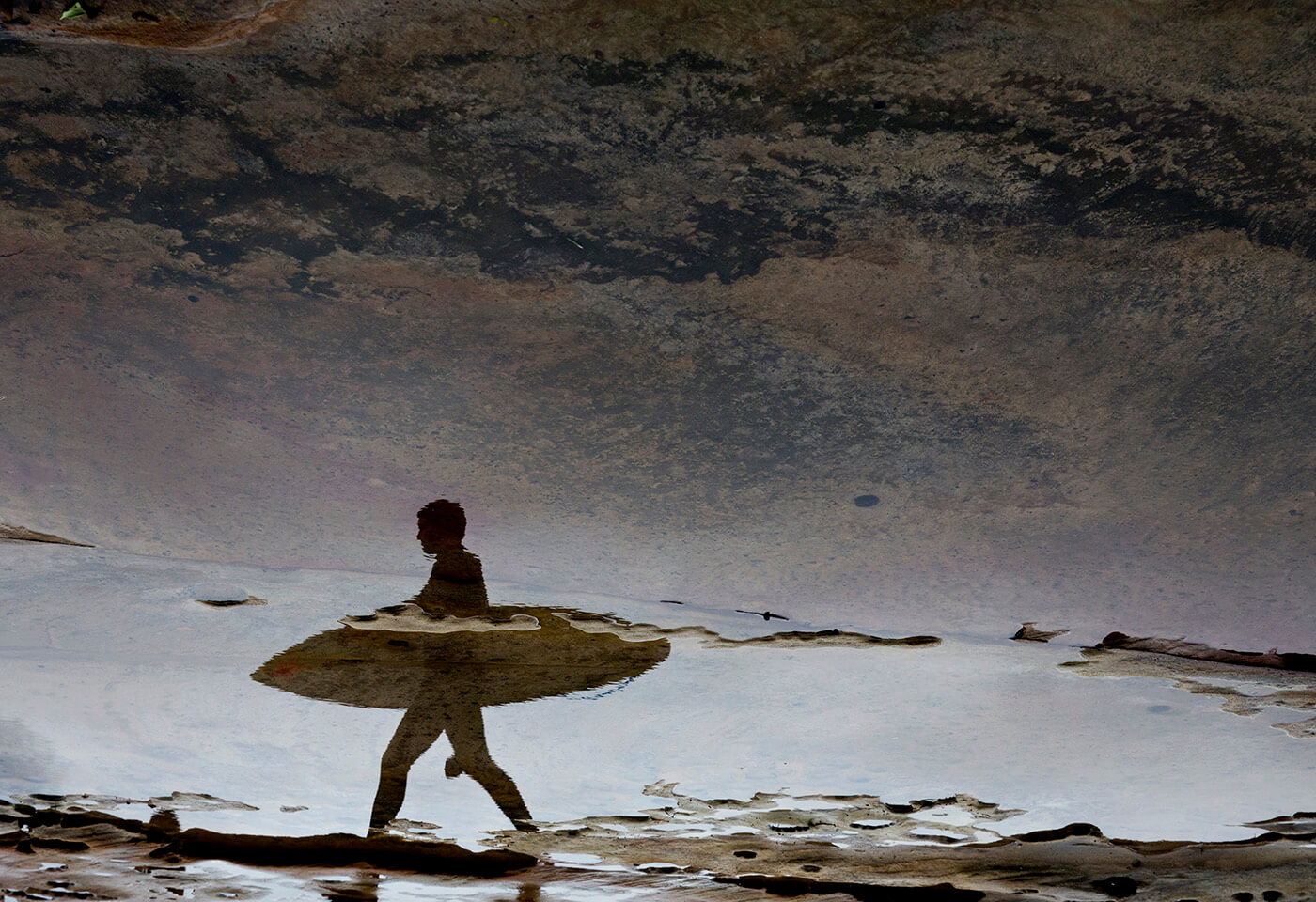 Image of surfer in reflection by Craig Golding
